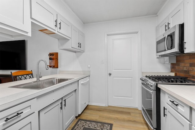 kitchen featuring stainless steel appliances and white cabinetry