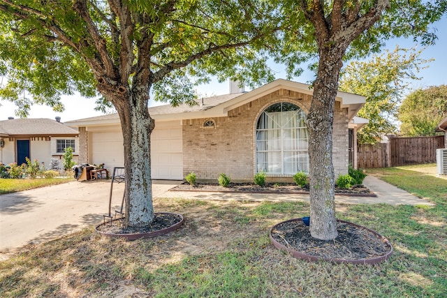 ranch-style home with cooling unit and a garage