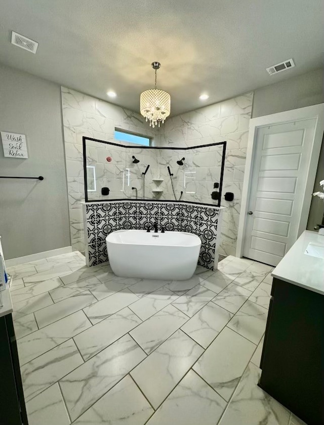 bathroom with vanity, tile walls, a textured ceiling, and separate shower and tub