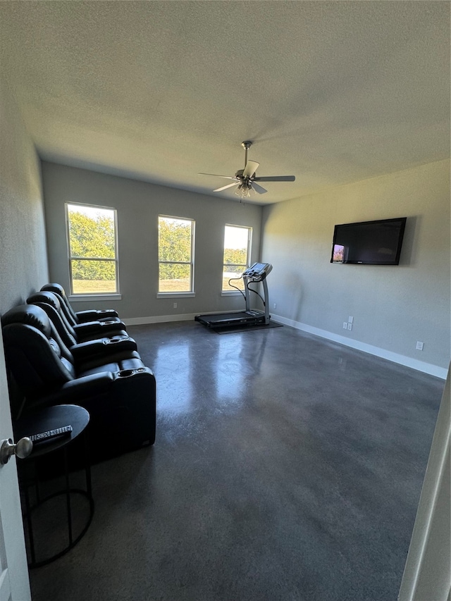 living room featuring a textured ceiling, a healthy amount of sunlight, and ceiling fan