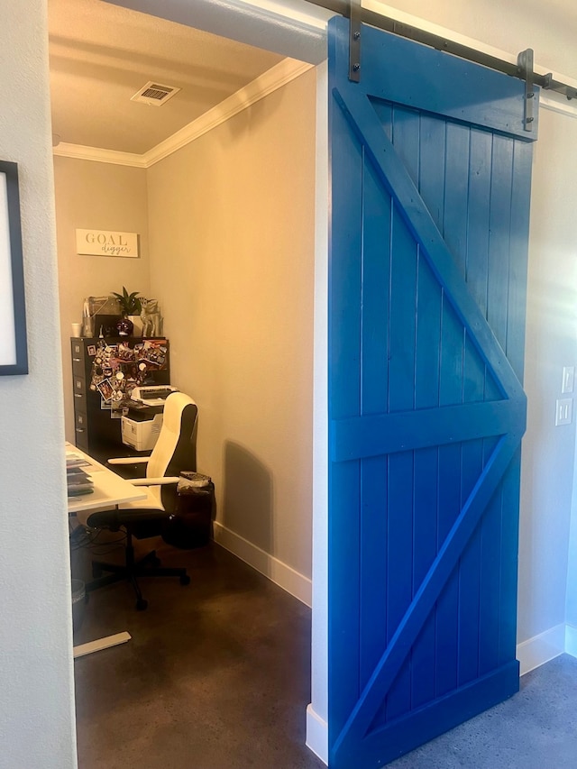 home office featuring crown molding, a barn door, and concrete floors