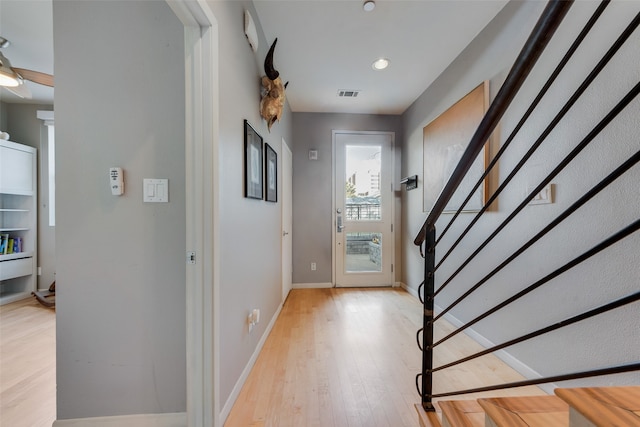 foyer entrance with light wood-type flooring and ceiling fan