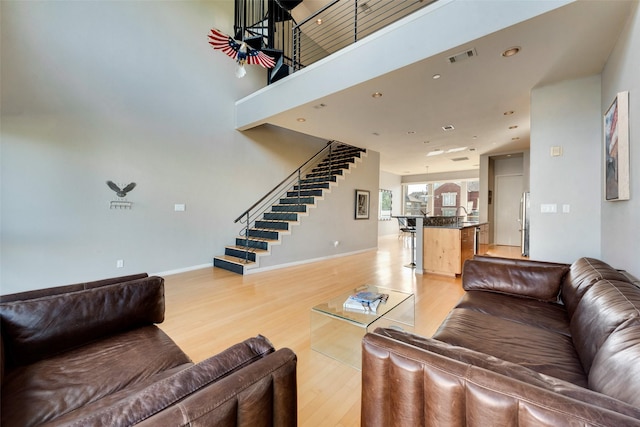 959 W Bluff St Unit 105, Fort Worth, TX 76102 - living room featuring stairs, light wood finished floors, baseboards, and recessed lighting