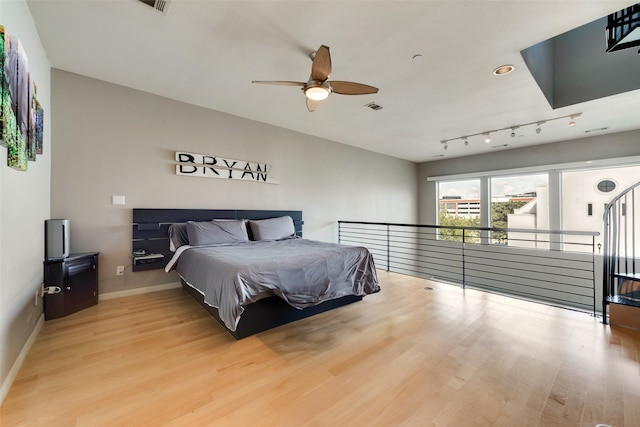 bedroom with wood-type flooring and ceiling fan