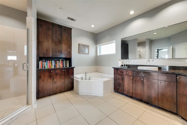 bathroom with vanity, plus walk in shower, and tile patterned flooring