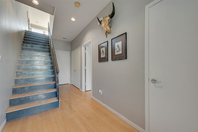 stairs with hardwood / wood-style floors