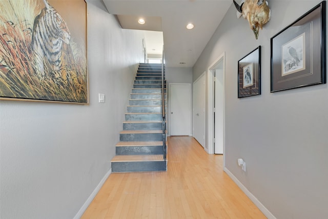 staircase with hardwood / wood-style floors