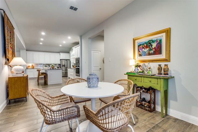 dining room with light hardwood / wood-style flooring