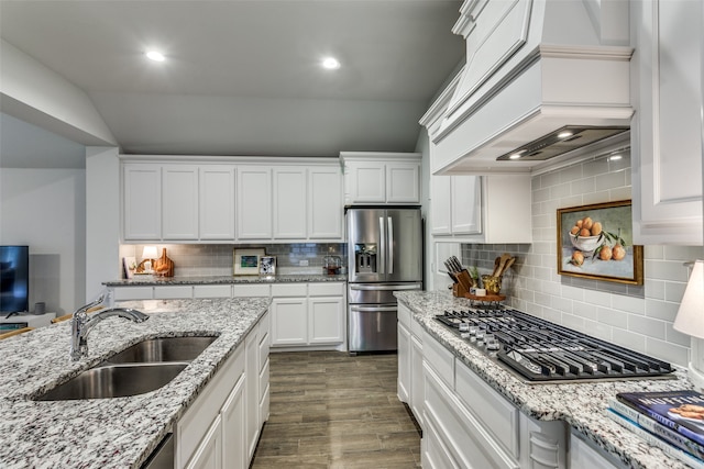 kitchen featuring custom exhaust hood, dark hardwood / wood-style flooring, appliances with stainless steel finishes, backsplash, and sink