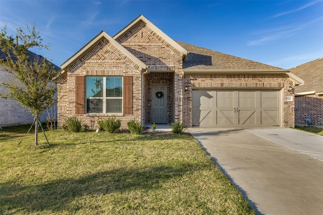 view of front of home featuring a front yard and a garage