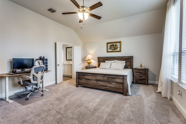 carpeted bedroom with lofted ceiling, ensuite bathroom, and ceiling fan