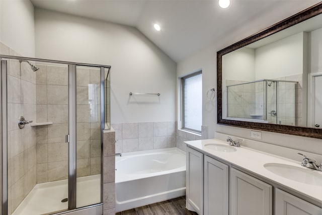 bathroom with vanity, shower with separate bathtub, wood-type flooring, and vaulted ceiling