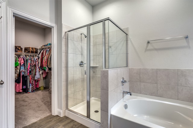 bathroom featuring hardwood / wood-style floors and shower with separate bathtub