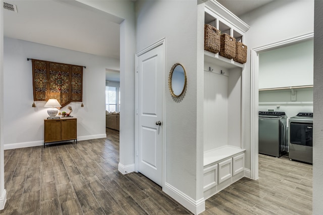 mudroom featuring wood-type flooring and washing machine and dryer