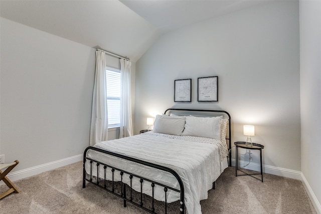 bedroom with carpet flooring and vaulted ceiling