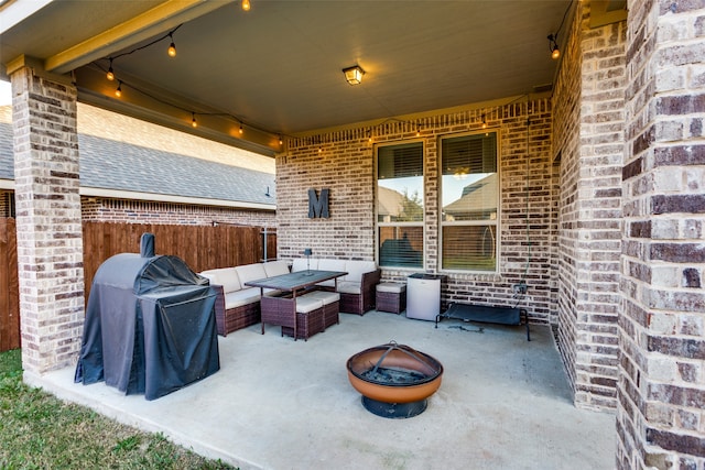 view of patio / terrace featuring an outdoor living space with a fire pit and a grill