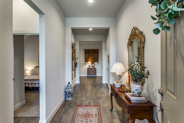 hallway with dark hardwood / wood-style floors