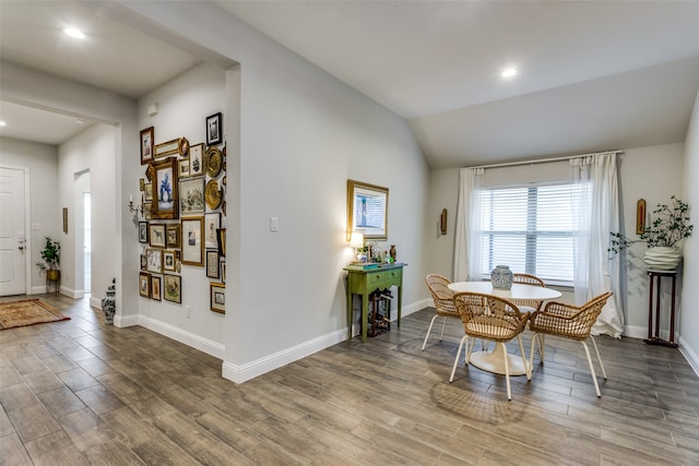 dining room featuring lofted ceiling and hardwood / wood-style flooring