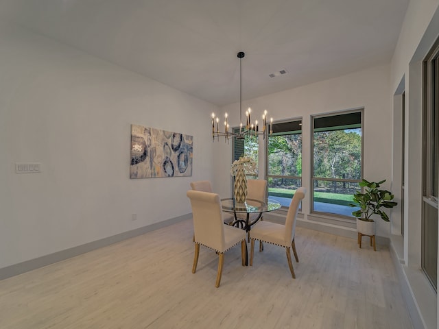 dining room with an inviting chandelier and light wood-type flooring