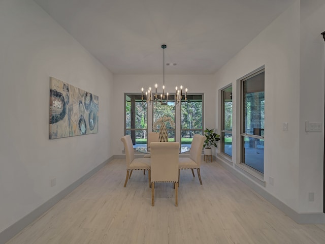 dining room featuring light hardwood / wood-style flooring and an inviting chandelier