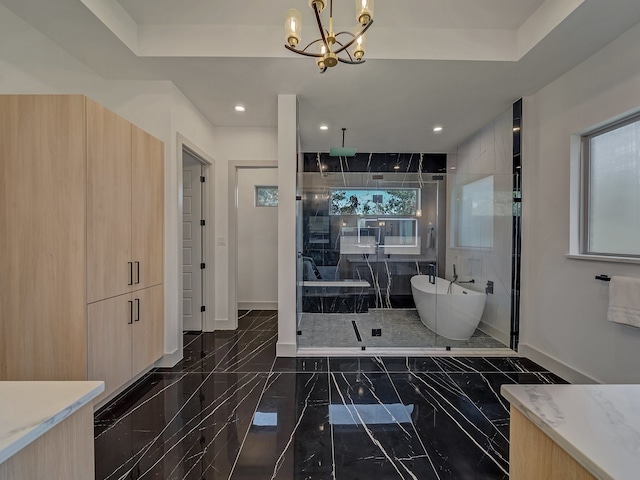 bathroom featuring vanity, plus walk in shower, and a wealth of natural light