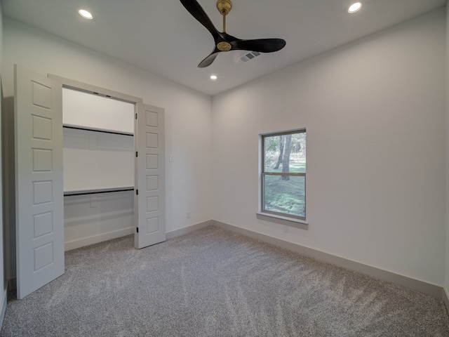 unfurnished bedroom with a closet, carpet, and ceiling fan