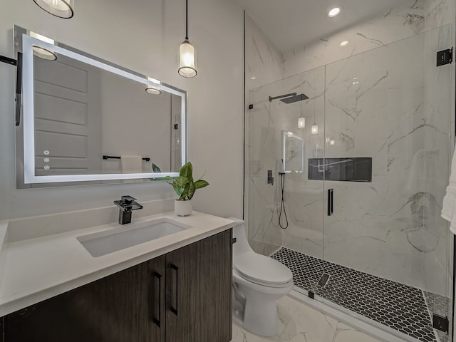 bathroom with vanity, toilet, and a shower with shower door