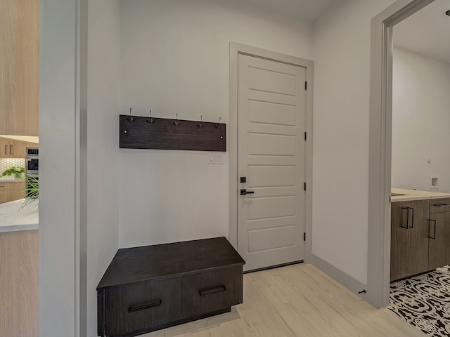 mudroom with light hardwood / wood-style floors