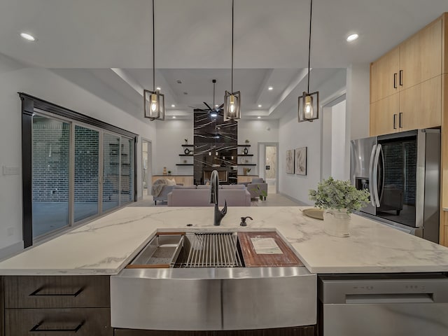 kitchen featuring light stone countertops, decorative light fixtures, white dishwasher, and stainless steel fridge with ice dispenser