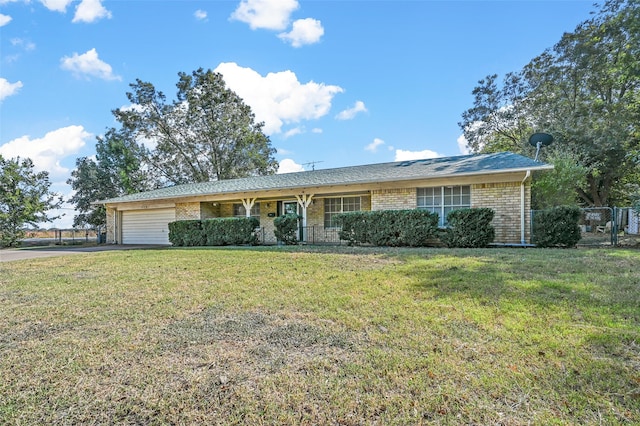 single story home with a garage and a front lawn