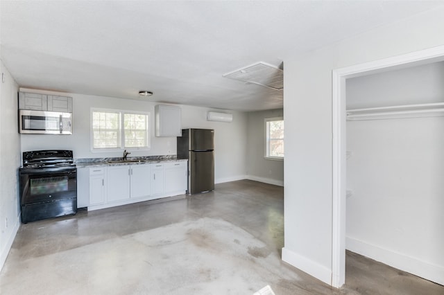 kitchen featuring a wealth of natural light, sink, appliances with stainless steel finishes, and white cabinets