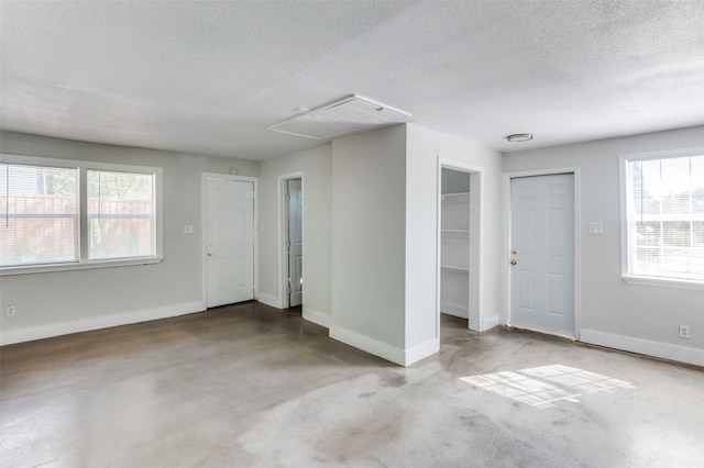 unfurnished room with a textured ceiling and carpet floors