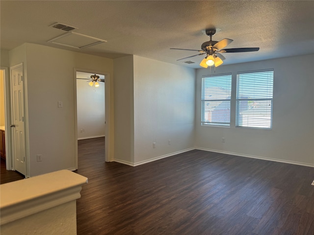 unfurnished room featuring ceiling fan, a textured ceiling, and dark hardwood / wood-style floors