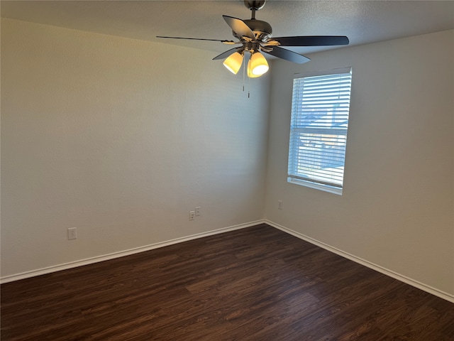 unfurnished room with ceiling fan and dark hardwood / wood-style floors