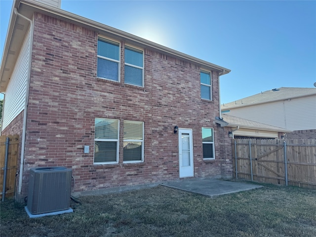 back of house with a patio area, cooling unit, and a lawn