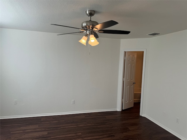 spare room featuring dark hardwood / wood-style floors, a textured ceiling, and ceiling fan