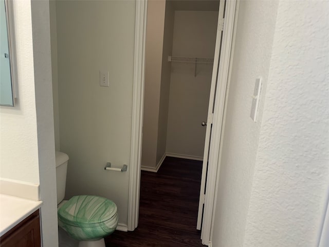 bathroom with vanity, toilet, and hardwood / wood-style flooring