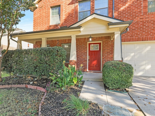 doorway to property featuring covered porch and a garage