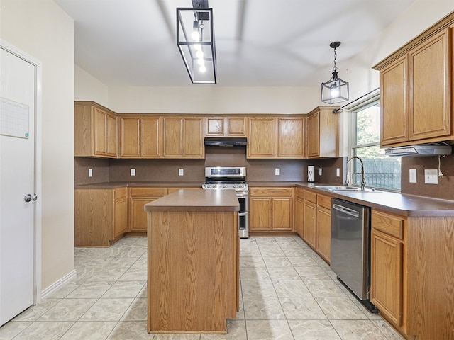 kitchen featuring appliances with stainless steel finishes, sink, a kitchen island, hanging light fixtures, and light tile patterned floors