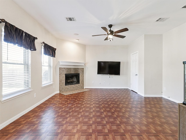 unfurnished living room with dark parquet floors and ceiling fan