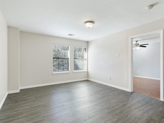 spare room with ceiling fan and dark hardwood / wood-style floors