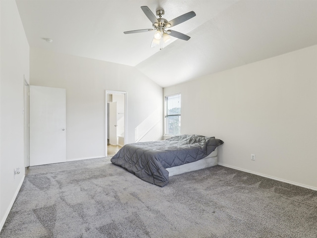 bedroom with ceiling fan, vaulted ceiling, ensuite bathroom, and carpet floors