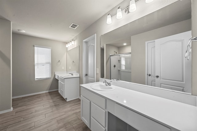 bathroom with vanity, hardwood / wood-style flooring, and an enclosed shower