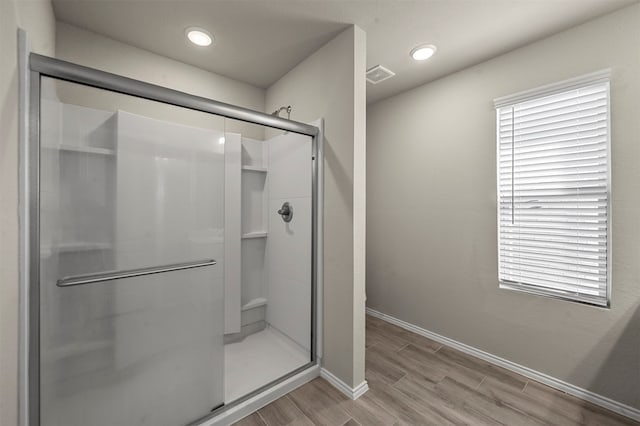 bathroom featuring an enclosed shower and hardwood / wood-style floors