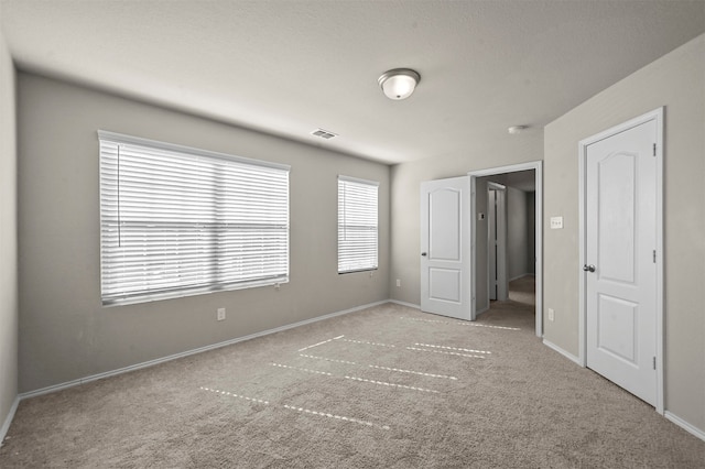 unfurnished bedroom featuring light colored carpet