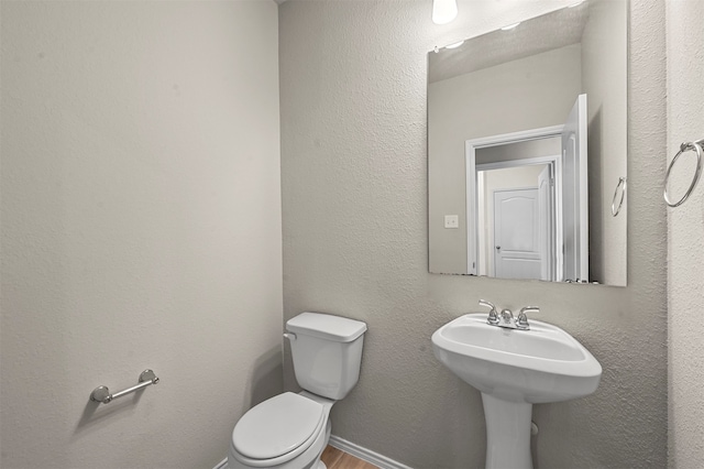 bathroom featuring toilet and hardwood / wood-style floors