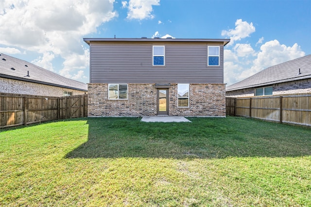 back of property featuring a yard and a patio area