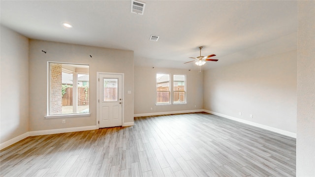 spare room with ceiling fan and light wood-type flooring