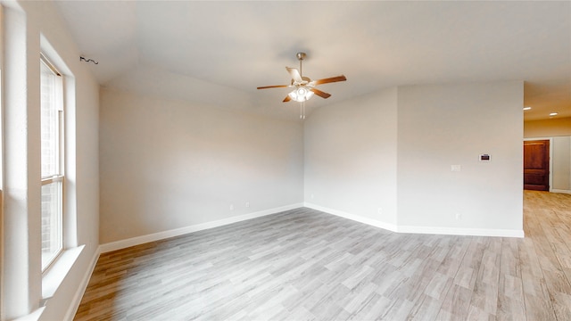 spare room with vaulted ceiling, light hardwood / wood-style flooring, and ceiling fan