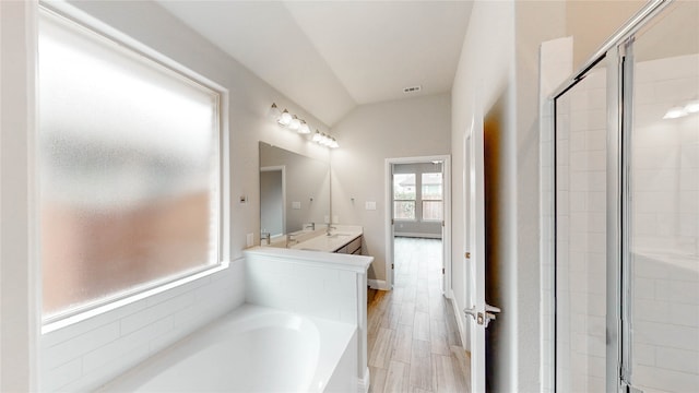 bathroom with vanity, lofted ceiling, independent shower and bath, and wood-type flooring